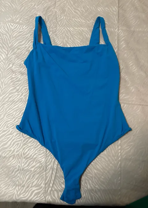 SKIMS Soft Stretch Bodysuit – Blue SKIMS bodysuit in a bright blue shade. Super soft and stretchy with a smooth, flattering fit. Only worn once and stored in a dresser since. No flaws.