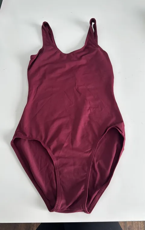 Burgundy woman’s leotard. Built in shelf bra. Size XS